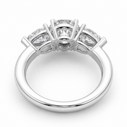 Underside view of a three stone lab-grown diamond engagement ring in white gold with a round center diamond and pear side diamonds.
